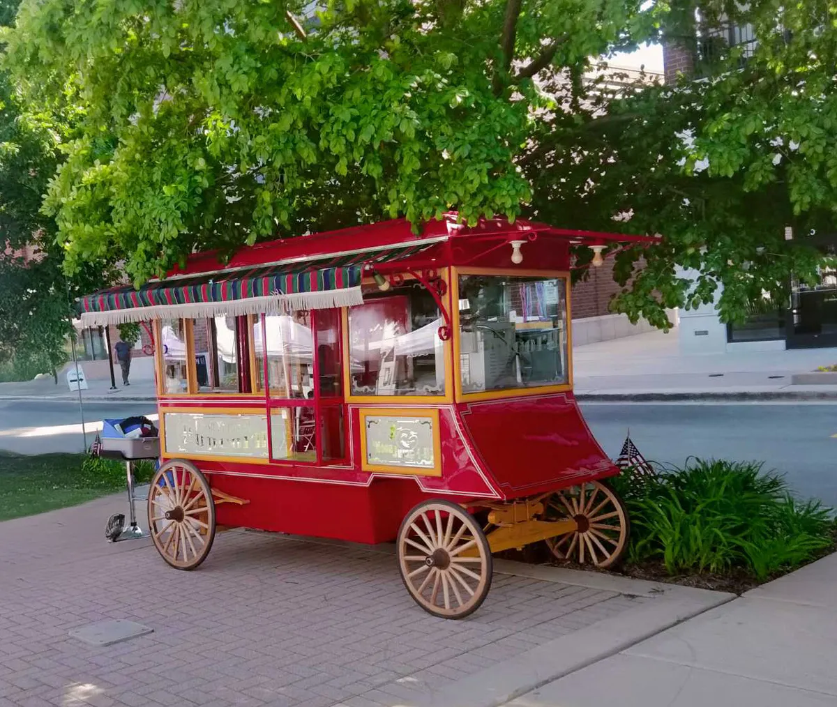 Vintage 1933 World's Fair popcorn wagon rental with red and white classic carriage styling from AMJ in Chicago