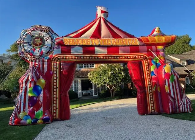 Large inflatable carnival archway event entrance, about 20 ft tall and 30 ft wide, framing a carnival event.