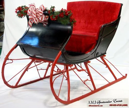 Santa's Cozy Sleigh, a red indoor holiday photo prop for malls, storefronts, and display windows
