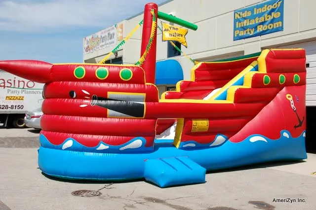 Pirate Ship inflatable slide and obstacle course rental with a 16ft slide and climb-in barrels for kids
