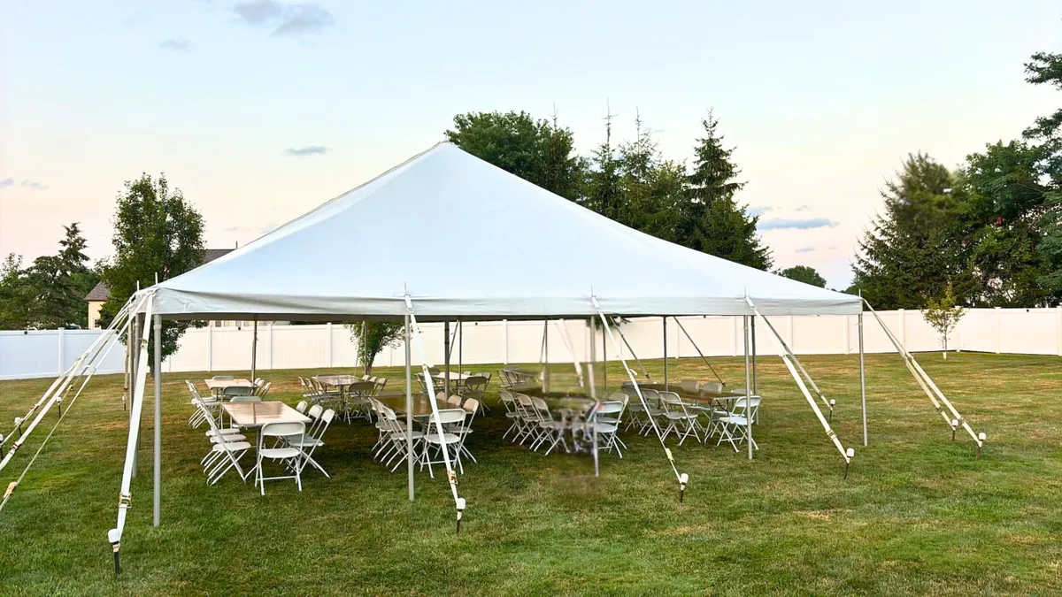 White 15x15 canopy tent rental set up on grass for an outdoor event in Chicagoland