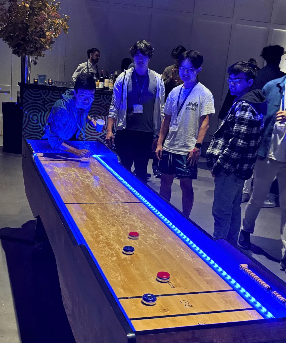 LED traditional-style 10ft shuffleboard table rental with red and blue playing weights from AMJ Spectacular Events