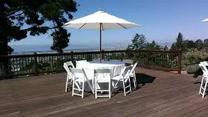 48in round table with white umbrella, stand, six white plastic chairs and round table cover rental
