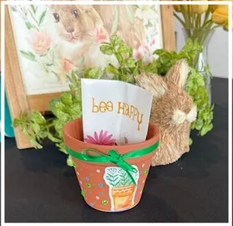 Flower Pot Craft make-and-take activity setup with supplies for guests to design their own flower pots