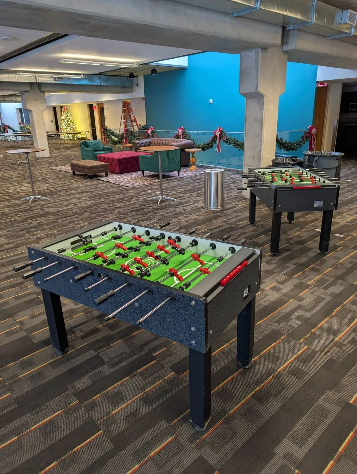 Four player foosball table rental with green playfield and colored player rods for Chicago events