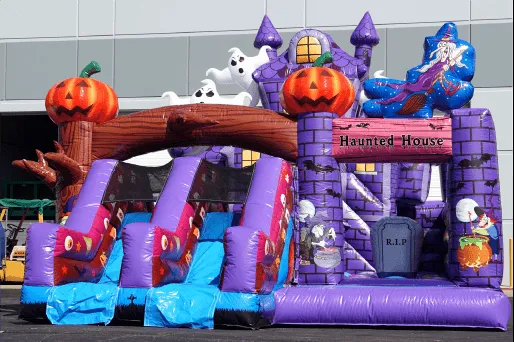 Happy Halloween Fun Village inflatable with pumpkins, ghosts, a maze, and slides for fall events