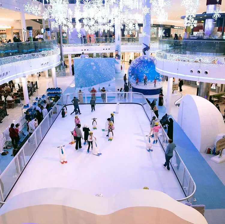 Commercial-grade iceless skating rink rental with perimeter fencing, benches, and skates for a Chicago event