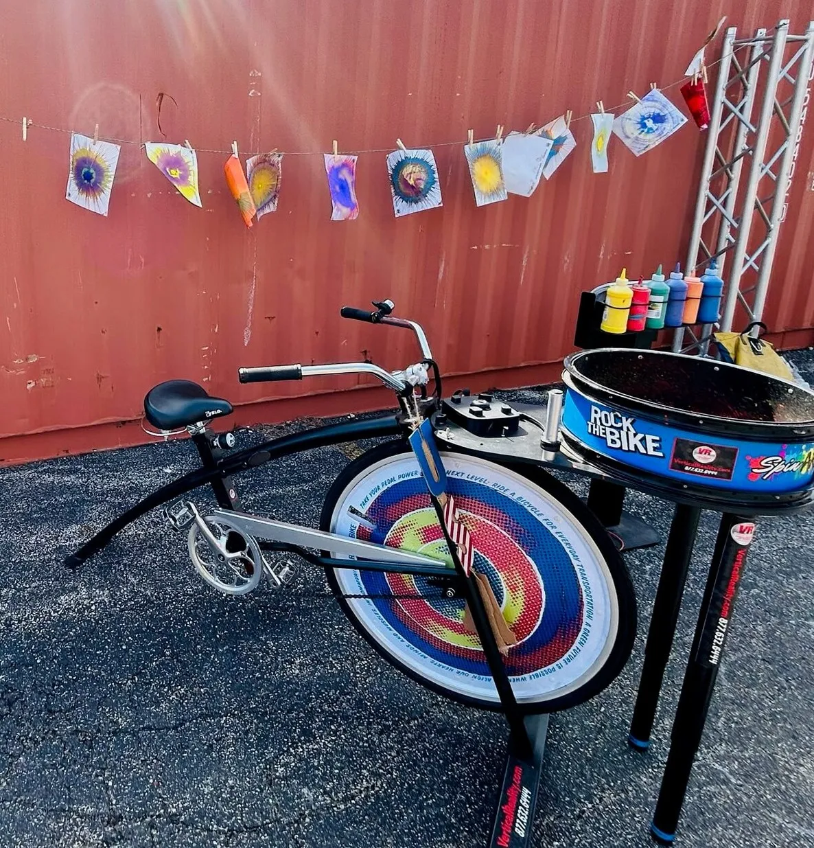 Pedal Powered Spin Art Bike rental where kids pedal to spin a platter and create colorful paint artwork