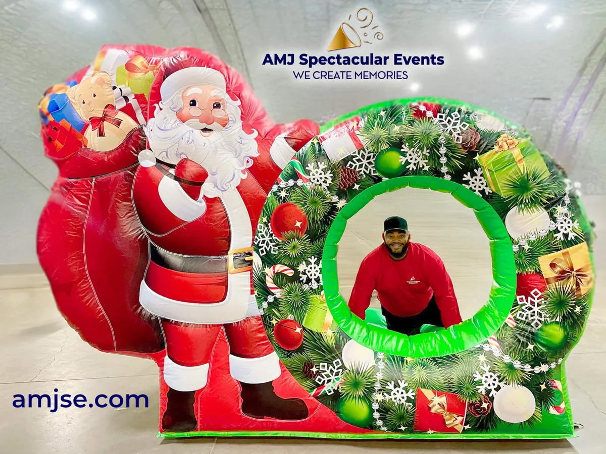 Inflatable Christmas Santa photo op with bright reds, greens, and whites and Santa at the entrance