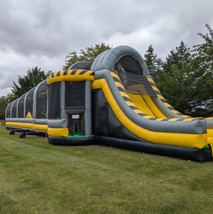 Toxic Drop inflatable obstacle course with climbing blocks, swaying wedge drop, and slide for Chicago events
