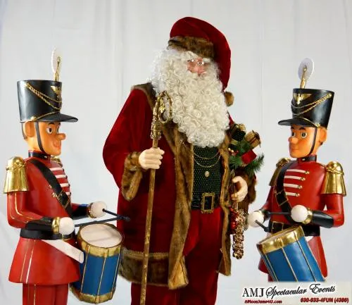 Life-sized Santa Claus statue with red velvet outfit, snow-white beard, gold glasses, and an armful of presents