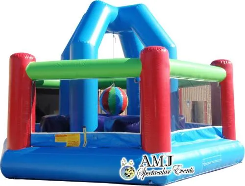Colorful green, red, and blue inflatable Wrecking Ball game rental with hanging ball for up to four players