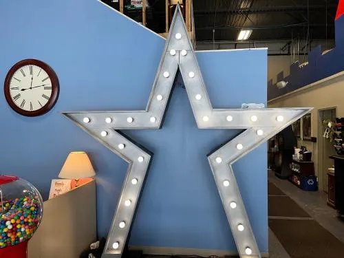 Illuminated 10-foot tall silver star backdrop for performances and photos at Chicago events
