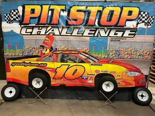Pit Stop Challenge interactive racing frame game rental where a pit crew swaps tires against the clock