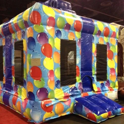 Colorful Gift Box inflatable bounce house with a giant bow and balloons for kids' birthday parties in Chicago