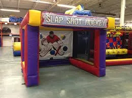 Slap Shot inflatable hockey target game rental with three hockey sticks from AMJ Spectacular Events Chicago