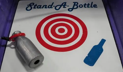 Stand A Bottle carnival skill game with pole and ring available for rental in Chicago