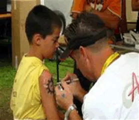 Airbrush Entertainer creating colorful temporary tattoos for guests at a Chicago event