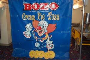 Bozo Cream Pie Toss frame game rental with clown theme for Chicago events