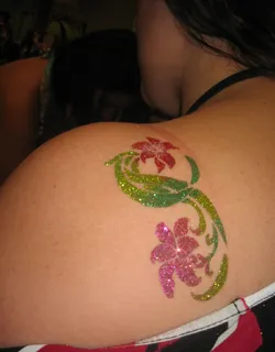 Temporary and glitter tattoo artist creating designs for kids at a Chicago event