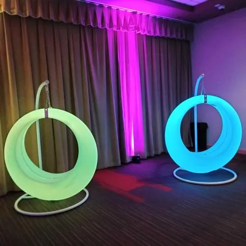 Glowing color-changing LED swing chair rental suspended for a Chicago party or wedding event
