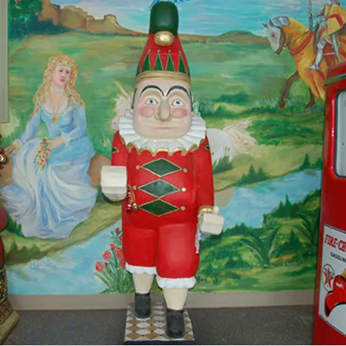 6-foot Jolly Elf statue in red, green, and gold holiday outfit available for rental in Chicago