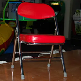 Pint-sized red vinyl kid's folding chair for children's parties, available for rent in Chicago from AMJ Spectacular Events