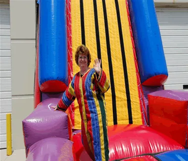 Inflatable Velcro Sticky Wall rental with participant in Velcro suit stuck to the wall